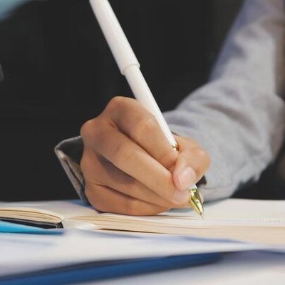 a-person-is-writing-on-a-piece-of-paper-with-a-pen-free-video